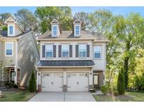 Charming two-story home featuring a two-car garage and neutral siding, with a well-maintained front yard at 3377 Park Pointe Cir, Scottdale, GA 30079