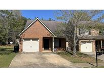 Charming brick townhome with a one-car garage and well-maintained front yard at 3108 Broadleaf Trl, Fairburn, GA 30213