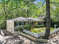 Charming single-story home with fresh landscaping and a white picket fence in a serene, tree-lined neighborhood at 2585 Acorn Ne Ave, Atlanta, GA 30305