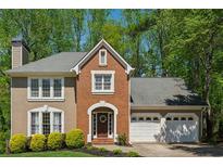 Charming two-story home features a brick facade, attached two-car garage and mature landscaping at 3362 Timber Rdg, Powder Springs, GA 30127