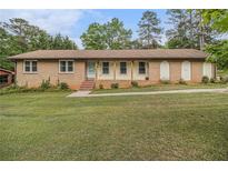 Charming ranch-style home featuring a brick facade and a well-manicured front yard at 6436 Alpine Rd, Rex, GA 30273