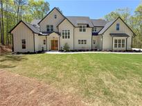 Stunning two-story home featuring a manicured lawn, symmetrical design, and impeccable curb appeal at 5567 Tyree Rd, Winston, GA 30187