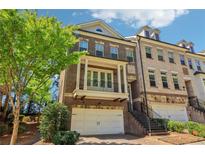 Charming two-story brick townhome featuring a private balcony and an attached two-car garage at 823 Canterbury Overlook, Atlanta, GA 30324