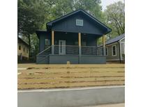 Charming home featuring a stylish front porch, modern railing and well-maintained landscaping at 1430 Fairbanks Sw St, Atlanta, GA 30310