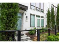 Charming townhome exterior featuring a modern painted brick facade, black trim, and well-maintained landscaping at 332 Gibson Se St, Atlanta, GA 30316