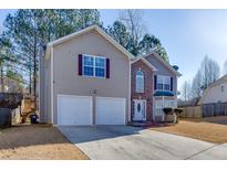 Charming two-story home with a two-car garage and brick entryway and well maintained lawn at 4089 Palm Dr, Snellville, GA 30039