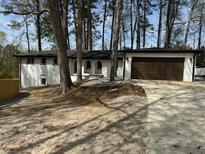 Inviting exterior view of a single-story home with well-maintained landscaping and attached garage at 3185 Hammarskjold Dr, East Point, GA 30344