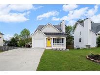 Charming single-story home featuring a yellow front door, attached garage, and well-maintained front yard at 131 Magazine St, Dallas, GA 30157
