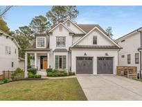 Charming two-story white brick home with a manicured lawn and a two-car garage at 2537 Thompson Ne Rd, Brookhaven, GA 30319