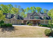 Spacious two-story home featuring a three-car garage and a well-manicured front yard at 1000 Holly St, Canton, GA 30114