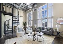 Bright living room with high ceilings, spiral staircase, and large windows offering ample natural light at 572 Edgewood Ne Ave # 301, Atlanta, GA 30312