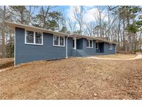 Charming single-story home featuring a gray brick facade and inviting front entrance at 4145 White Oak Dr, Winston, GA 30187