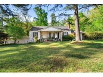 Charming one-story home with a large, grassy front yard and mature trees at 2004 Cedar Grove Rd, Conley, GA 30288
