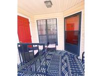 Cozy patio area with woven chairs and a stylish blue patterned rug, perfect for relaxing outdoors at 705 Windchase Ln, Stone Mountain, GA 30083