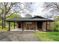 Charming brick home featuring a covered entrance, well-maintained landscaping, and a welcoming facade at 80 E Howard St, Kingston, GA 30145
