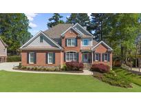 Lovely brick home with well-kept lawn, featuring classic architecture and dark shutters at 6252 Fernstone Trl, Acworth, GA 30101