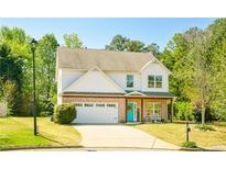 Two-story home features a well-maintained lawn, a two-car garage, brick accents and a welcoming entrance at 2365 Oakland Trail Way, Lawrenceville, GA 30044