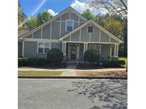 Charming home featuring manicured landscaping, gray facade, and inviting front porch at 278 Mission Oak Se Dr, Grayson, GA 30017