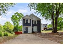 Charming two-story home featuring a well-maintained yard and inviting curb appeal on a sunny day at 1647 Imperial Ct, Norcross, GA 30093