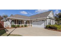 Charming one story home with a concrete driveway and well manicured landscaping at 307 Jessica Way, Canton, GA 30114