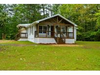 Charming cottage-style home with a welcoming front porch and nicely landscaped yard at 505 Cedar Creek Nw Rd, Cartersville, GA 30121