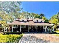 Charming one-story home with a sprawling front porch and inviting curb appeal at 2245 Panstone Sw Dr, Marietta, GA 30060