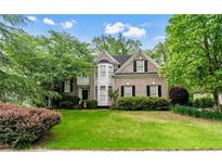 Charming two-story brick home with manicured lawn, mature trees, and a beautiful bay window feature at 1270 Cameron Crk, Marietta, GA 30062
