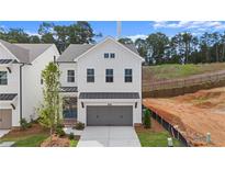 Charming two-story home with white siding, a gray garage door, and a neatly manicured front yard at 683 Summitt Hill Way, Cumming, GA 30040