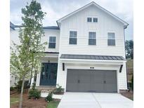 Charming two-story home with white siding and a two-car garage at 683 Summitt Hill Way, Cumming, GA 30040