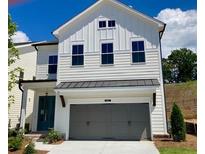 Charming two-story home with a gray attached garage and manicured lawn at 683 Summitt Hill Way, Cumming, GA 30040