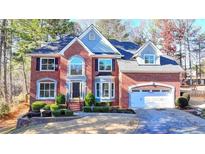 Stately two-story brick home with a manicured lawn and attached two car garage at 1081 Talon Trce, Lawrenceville, GA 30043