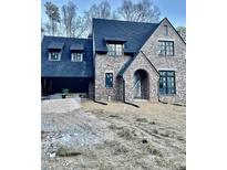 Stately brick home featuring a gabled roof, dormer windows, and a covered entry way at 2461 Fernleaf Nw Ct, Atlanta, GA 30318