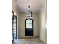 Beautiful foyer with black door and lantern-style light fixture at 2461 Fernleaf Nw Ct, Atlanta, GA 30318