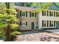 Charming two-story townhouse with tan siding, green shutters, and beautiful stone walkway at 706 Twin Brooks Se Ct, Marietta, GA 30067