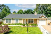 Charming ranch-style home with manicured lawn, white trim, and inviting curb appeal at 1081 Singleton Valley Cir, Norcross, GA 30093