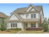 Charming two-story home with light siding, well-manicured landscaping, and inviting front porch at 245 Fender Walk, Marietta, GA 30060
