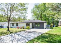 Charming single-story home with a well-maintained lawn and modern front door at 3719 Paul St, Douglasville, GA 30135