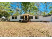 Charming single-story home featuring white siding, dark blue shutters, and a welcoming front porch at 56 Windom Dr, Carrollton, GA 30116