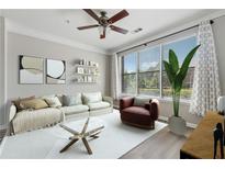 Bright living room featuring large windows, ceiling fan, neutral decor, and modern furnishings at 400 17Th Nw St # 2029, Atlanta, GA 30363