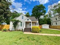 Charming home with a well-manicured front yard, welcoming porch, and beautiful landscaping at 2010 Bixby Se St, Atlanta, GA 30317