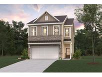 Charming two-story home featuring a two-car garage, brick accents, and a well-manicured lawn at 1022 Sutherland Lane (Lot 42), Lawrenceville, GA 30043