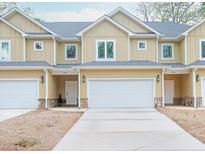 Charming townhomes featuring a durable driveway and convenient attached two-car garage at 6880 Robinson St, Lithonia, GA 30058