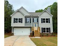 Charming two-story home features a two-car garage, traditional black shutters, and a classic gray and white color scheme at 48 Deer Pl, Villa Rica, GA 30180