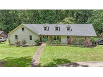 Charming single-story home with a beautifully landscaped front yard and a welcoming entrance at 527 Gaddis Rd, Canton, GA 30115