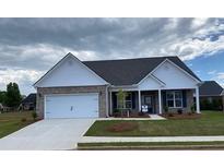 Beautiful brick house with well-manicured lawn, covered porch, and two-car garage at 911 Park Place St, Social Circle, GA 30025