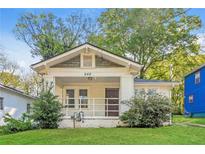 Charming single-story home featuring a quaint front porch and well-maintained lawn at 946 Crew Sw St, Atlanta, GA 30315