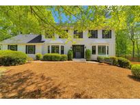 Charming two-story traditional home featuring black shutters and a well-manicured front yard at 3040 Greenfield Dr, Marietta, GA 30068