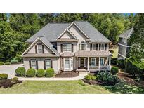 Charming two-story home with manicured landscaping and a welcoming front porch at 629 Gold Valley Pass, Canton, GA 30114