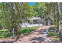 Charming renovated home boasts a quaint covered porch, driveway and lush natural surroundings at 1679 Hollyhock Ter, Decatur, GA 30032