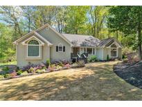 Charming single story home with well-maintained landscaping and inviting curb appeal on a sunny day at 1819 Yorkshire Dr, Woodstock, GA 30189